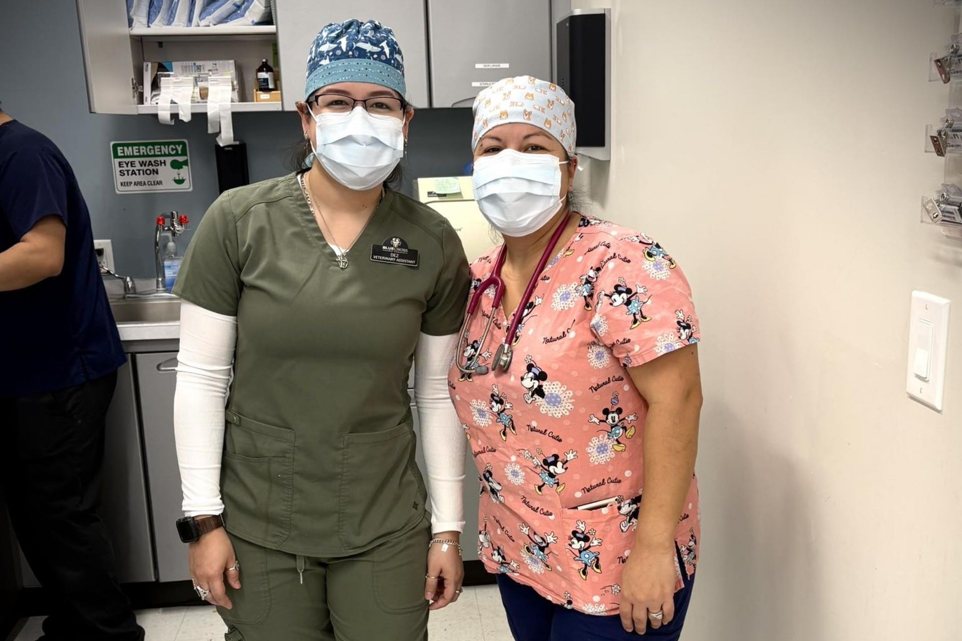 Two vet staff wearing masks and scrubs